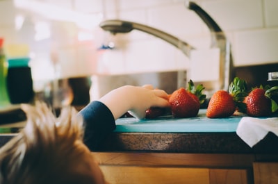 孩子在厨房里摘草莓